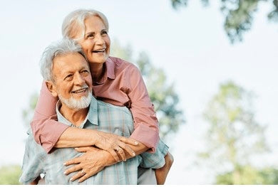 "Happy senior couple outdoors enjoying a healthy lifestyle. Discover how a fitness tracker improved sleep quality and overall well-being in this inspiring customer story."